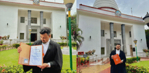 Naziz Afruz, law graduate and newly inducted Bar Council member, in formal attire outside Gauhati High Court.