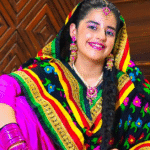 Dilnoor Sanghera performing a modern dance move in stylish outfit